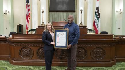 Assemblymember Cooper presents Jennifer Freeworth an Assembly Resoution on her retirement.