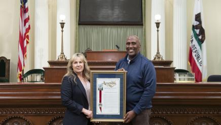 Assemblymember Cooper presents Jennifer Freeworth an Assembly Resoution on her retirement.