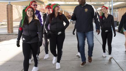 Assemblymember Cooper walking with his staff at the turkey giveaway event